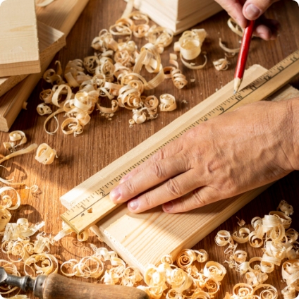 Carpenter measuring wood to cut